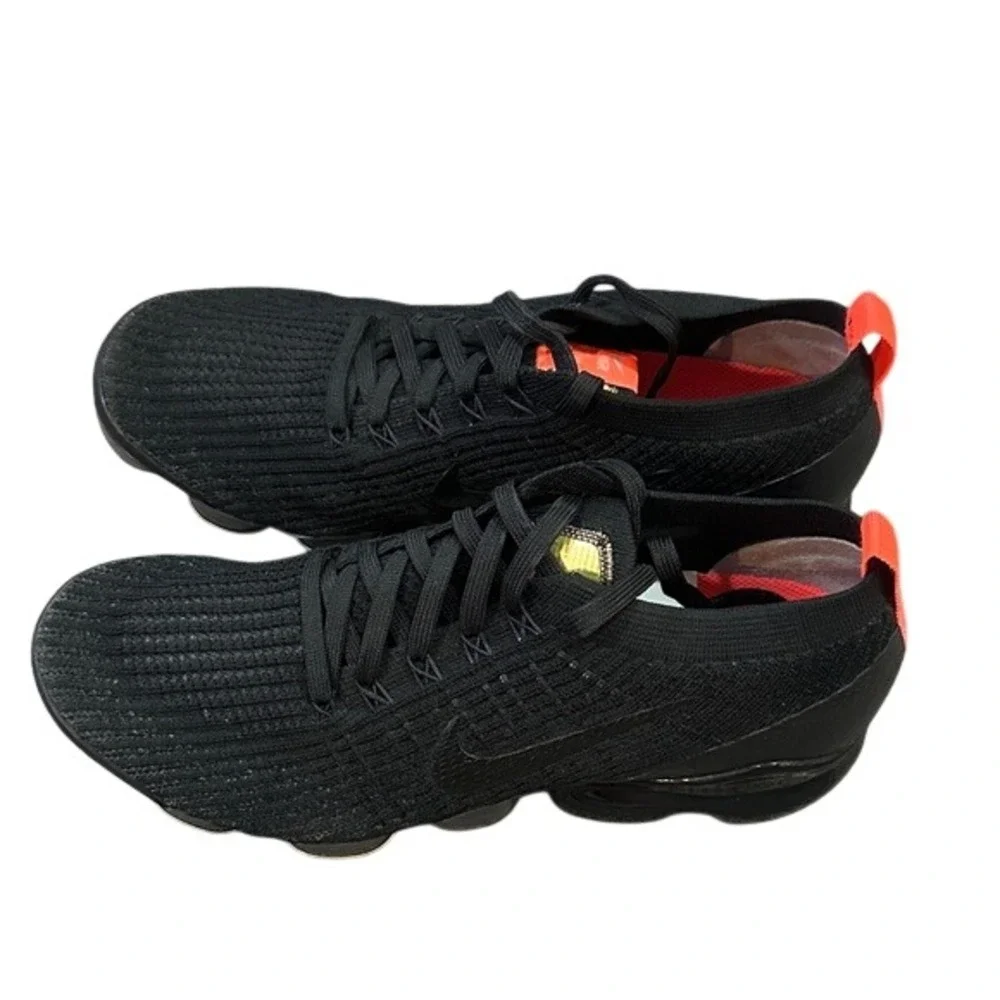 black Nike Air VaporMax Flyknit 3 sneakers with bright crimson/orange accents